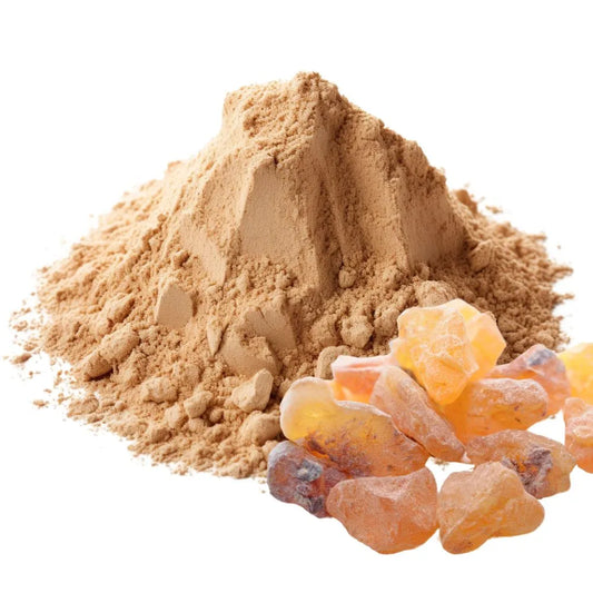 Pile of Boswellia powder with chunks of raw resin beside it, highlighting the natural amber and orange colors of the resin, isolated on a white background.