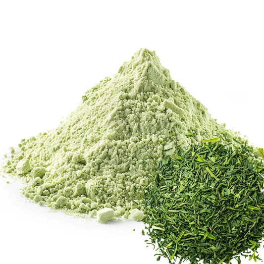 Heaped pile of green tea powder next to a fresh mound of chopped green tea leaves, isolated on a white background - WowNutri