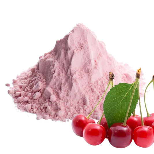 Soft pink tart cherry powder heaped in a mound, accompanied by fresh red tart cherries with green leaves, isolated on a white background for WowNutri.